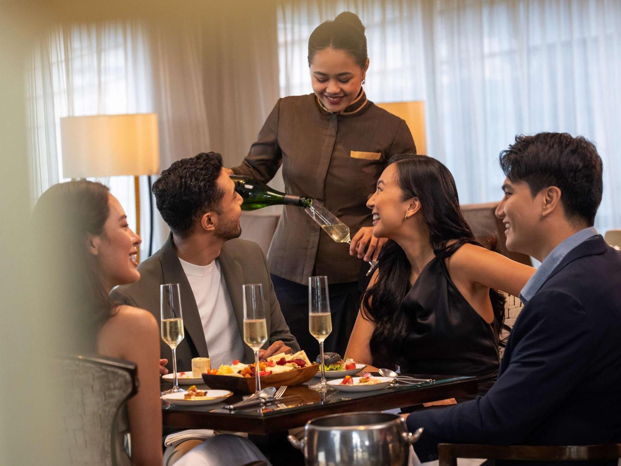Fairmont Makati Hotel Makati City Exterior photo A butler serving drinks at a party