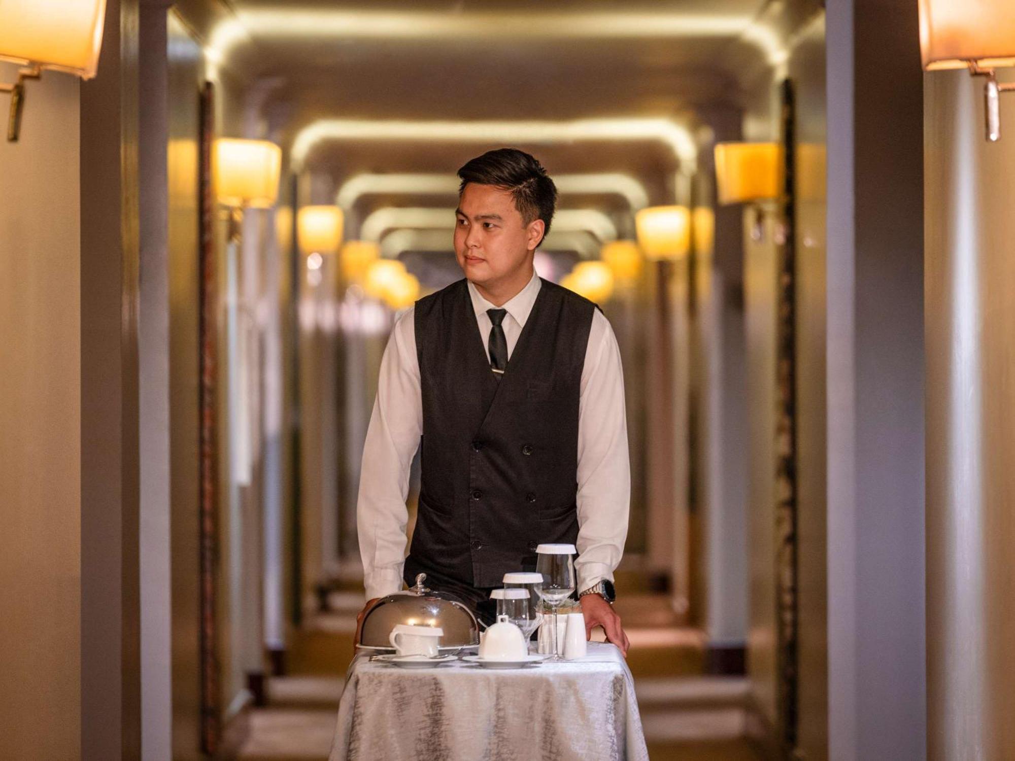 Fairmont Makati Hotel Makati City Exterior photo A room service attendant at work